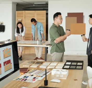 two-office-workers-with-drinks-discussing-working-2023-11-27-05-36-21-utc